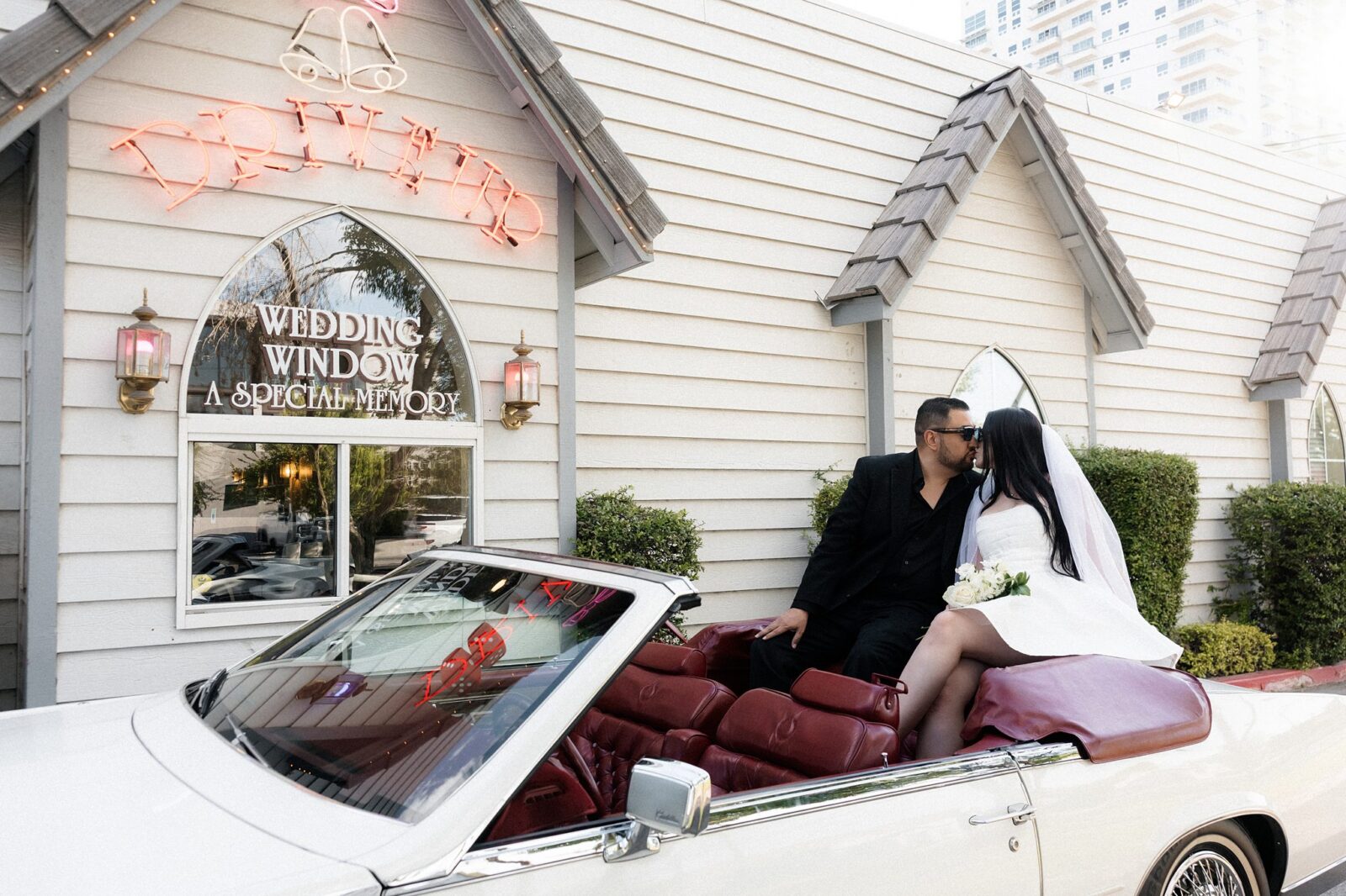 Wide shot of a bride and groom kissing in the back of The Risky Ride at A Special Memory Wedding Chapel in Las Vegas.