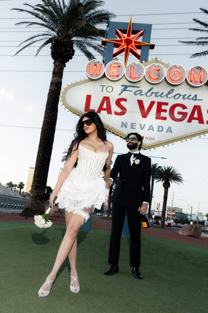 Couple posing outside of the Welcome to Fabulous Las Vegas Sign.