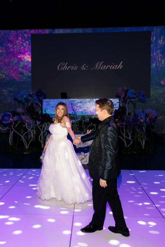 Bride and groom posing in their Taylor Swift Enchanted inspired AREA15 Las Vegas wedding reception.