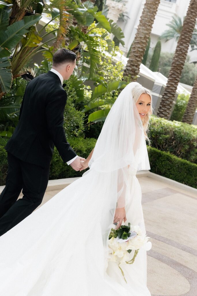 Bride and groom walking through the gardens at Caesars Palace.