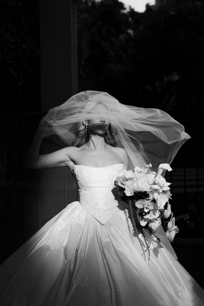 Black and white dramatic shot of a bride posing under her veil at Caesars Palace.