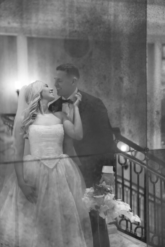 Black and white photo of a bride and groom posing at Caesars Palace.