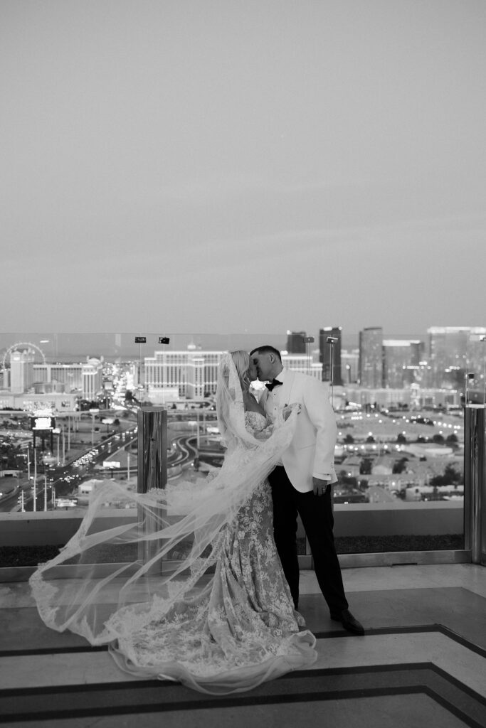 Black and white photo of a bride and groom kissing on the rooftop at Ghostbar at The Palms.