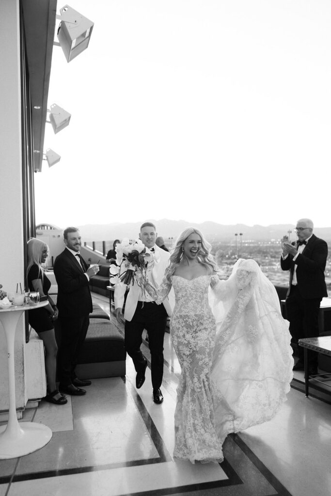 Black and white photo of the bride and groom entering their Ghostbar at The Palms La Vegas wedding reception,