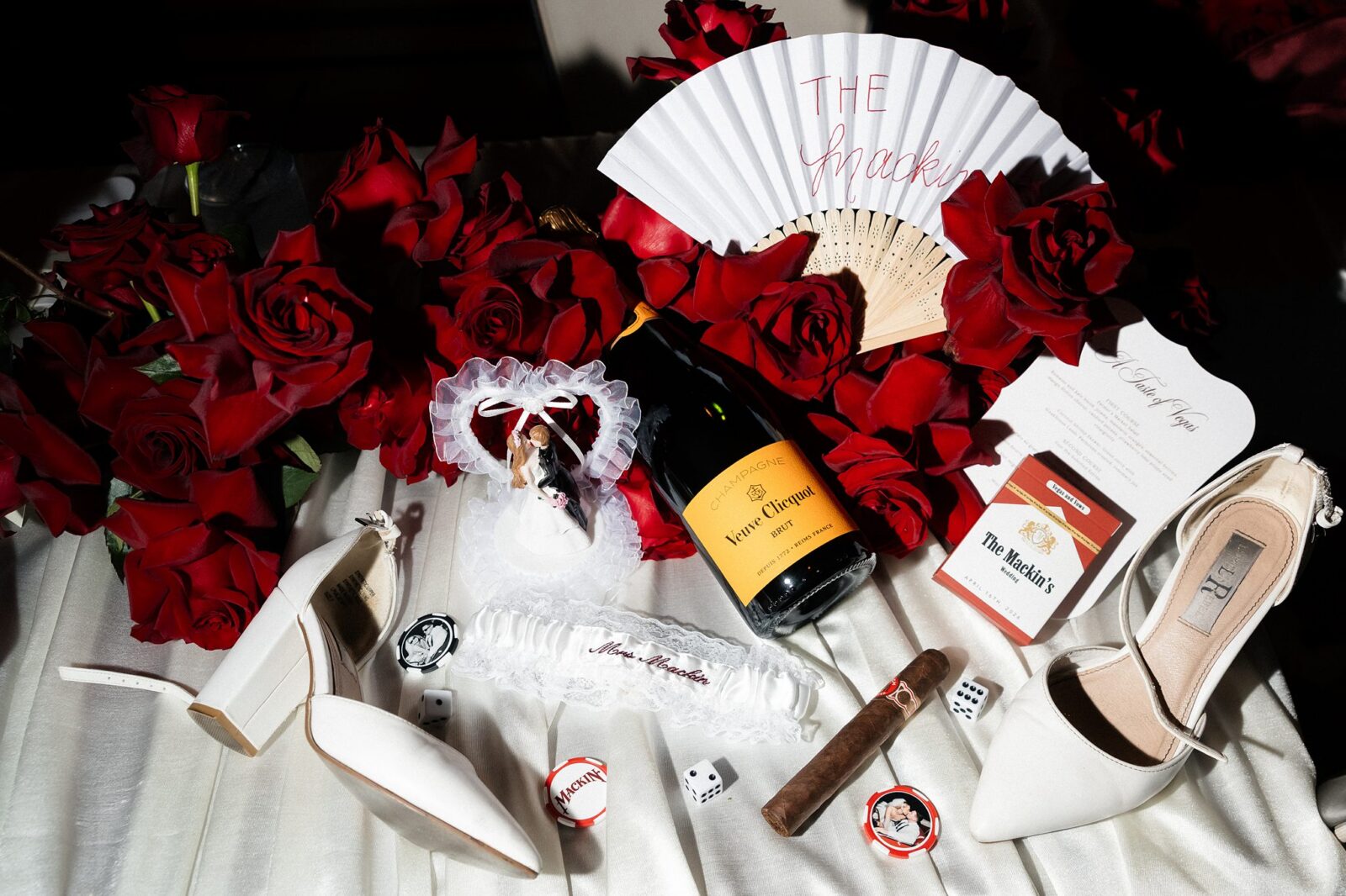 Las Vegas wedding reception detail photos with florals, custom fans, champagne, cigars, playing dice, and more,