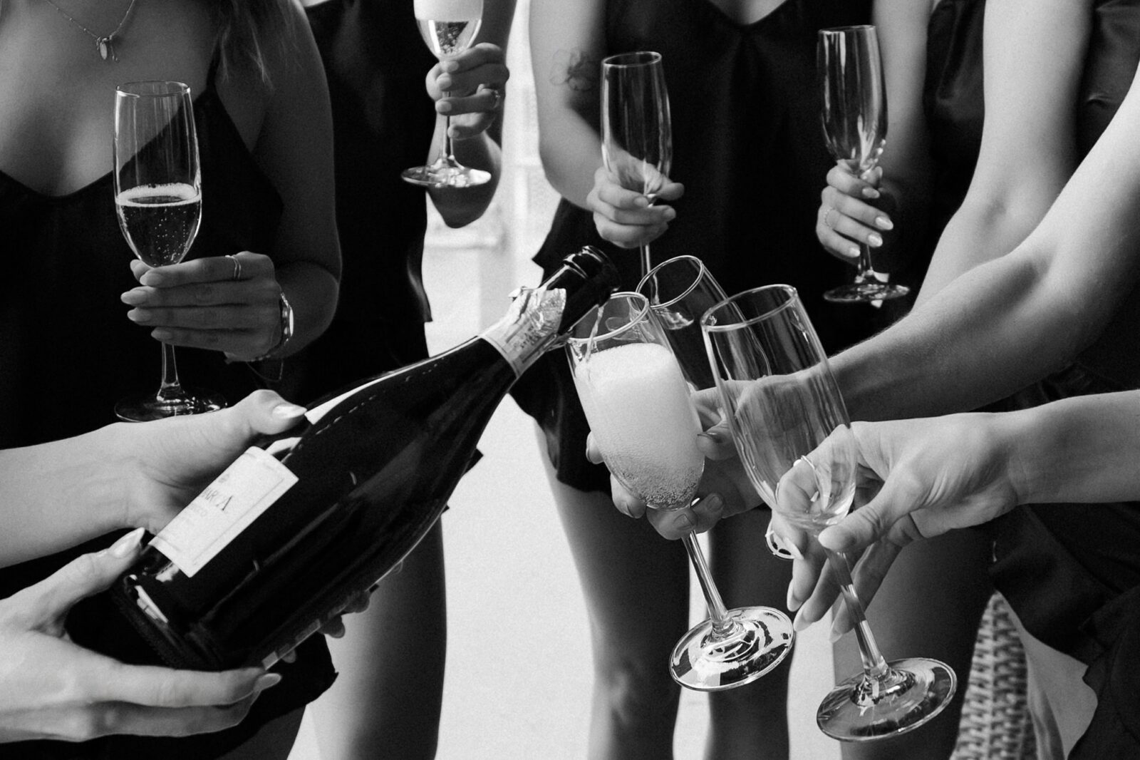 Champagne being poured into glasses during wedding morning getting ready photos at The Cosmopolitan Las Vegas.
