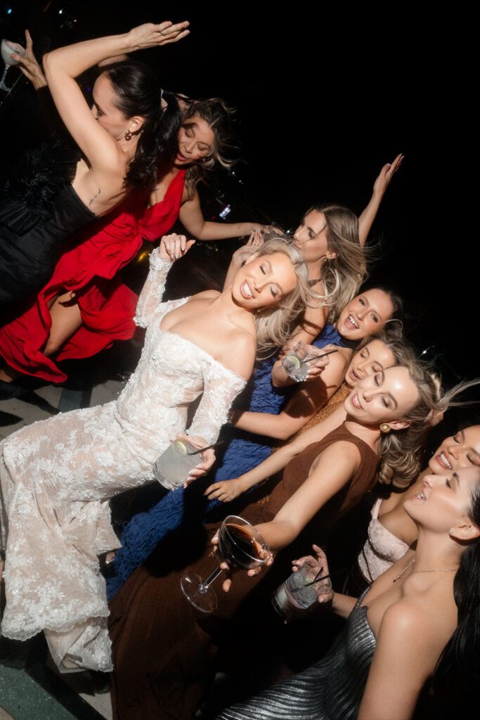 Bride dancing with friends during her rooftop wedding reception at The Palms Ghost Bar.