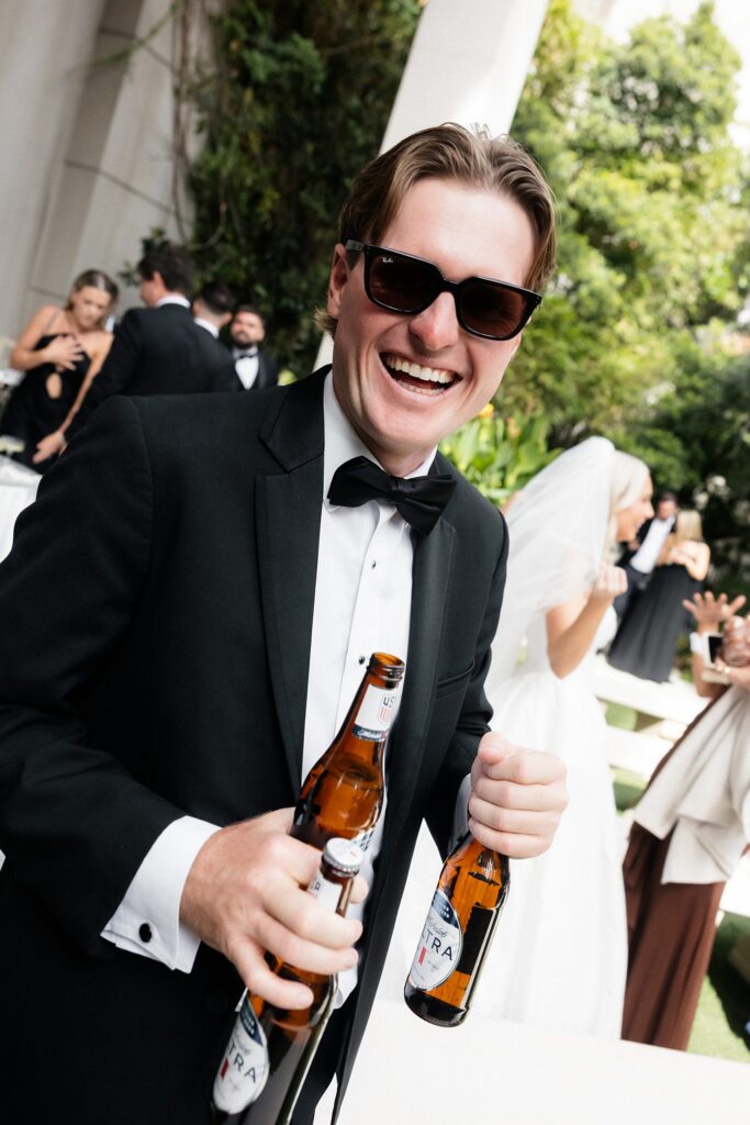 Guest holding three beers.