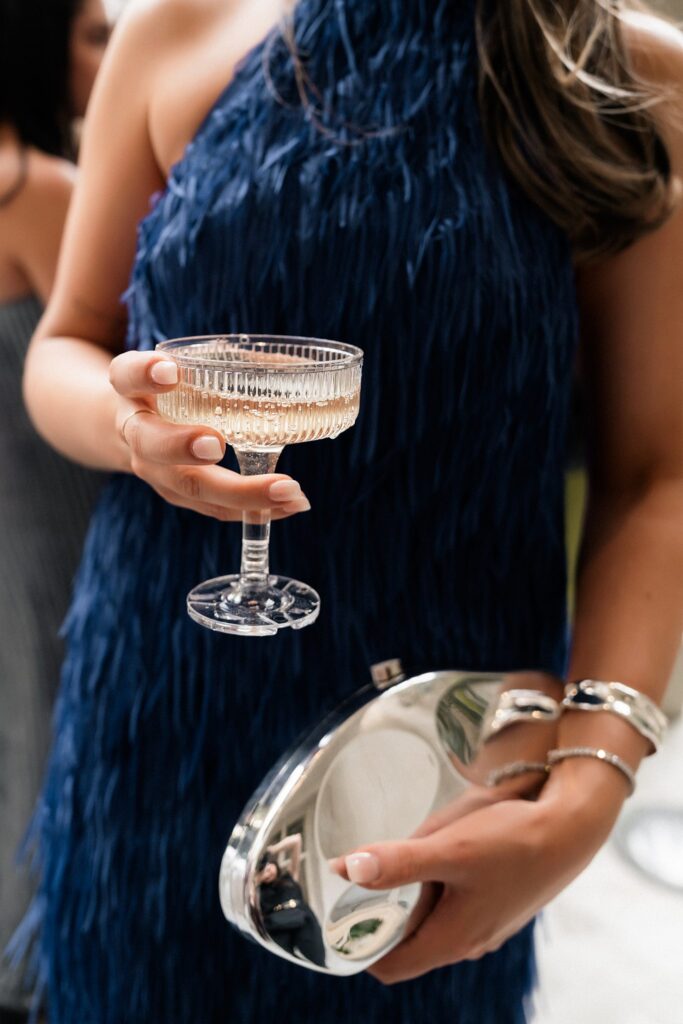 Guest holding a glass of champagne.