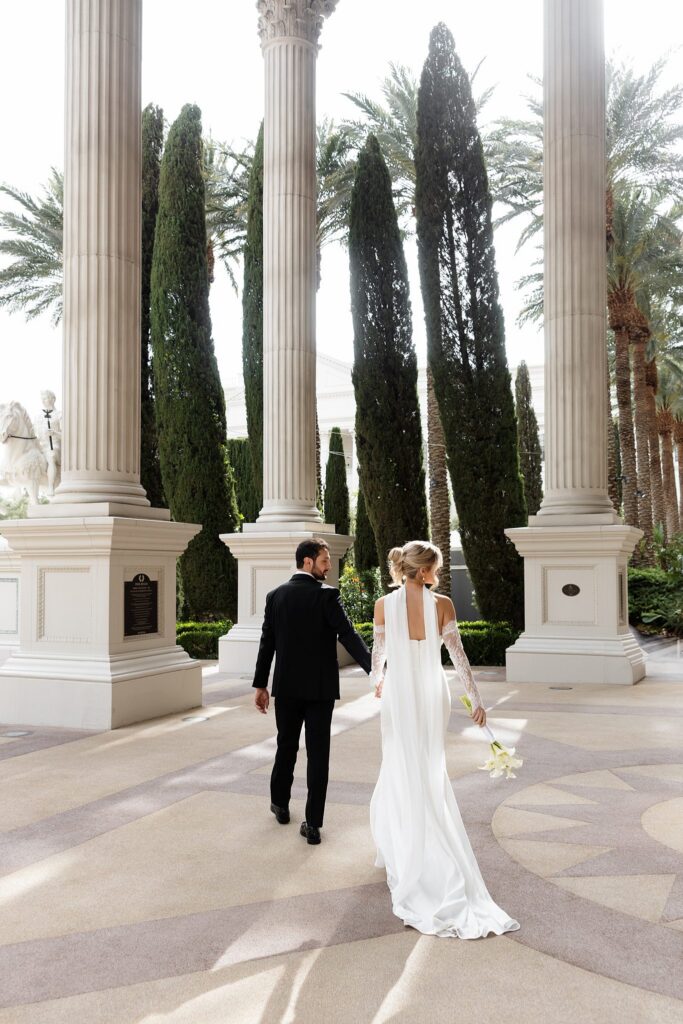 Bride and groom walking through the grounds at Caesars Palace in Las Vegas.