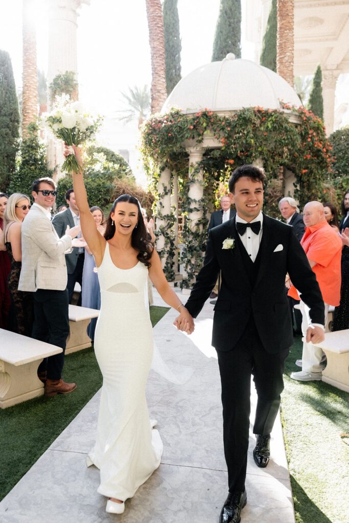 Bride and groom walking back down the aisle after their Caesars Palace Venus Garden wedding ceremony.