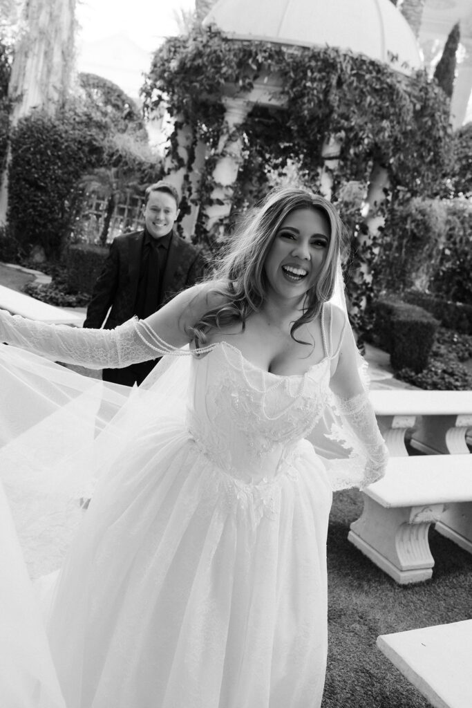 Black and white portrait of a bride and groom posing in the Venus Garden at Caesars Palace.