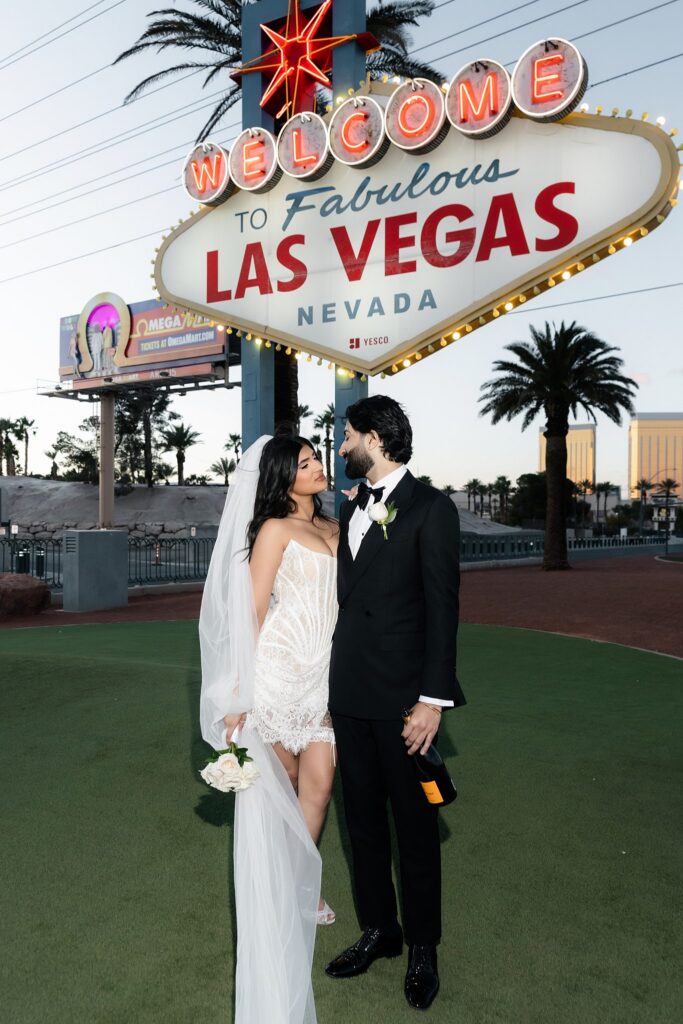 Couple posing in front of the Welcome to Fabulous Las Vegas sign for their engagement photos.