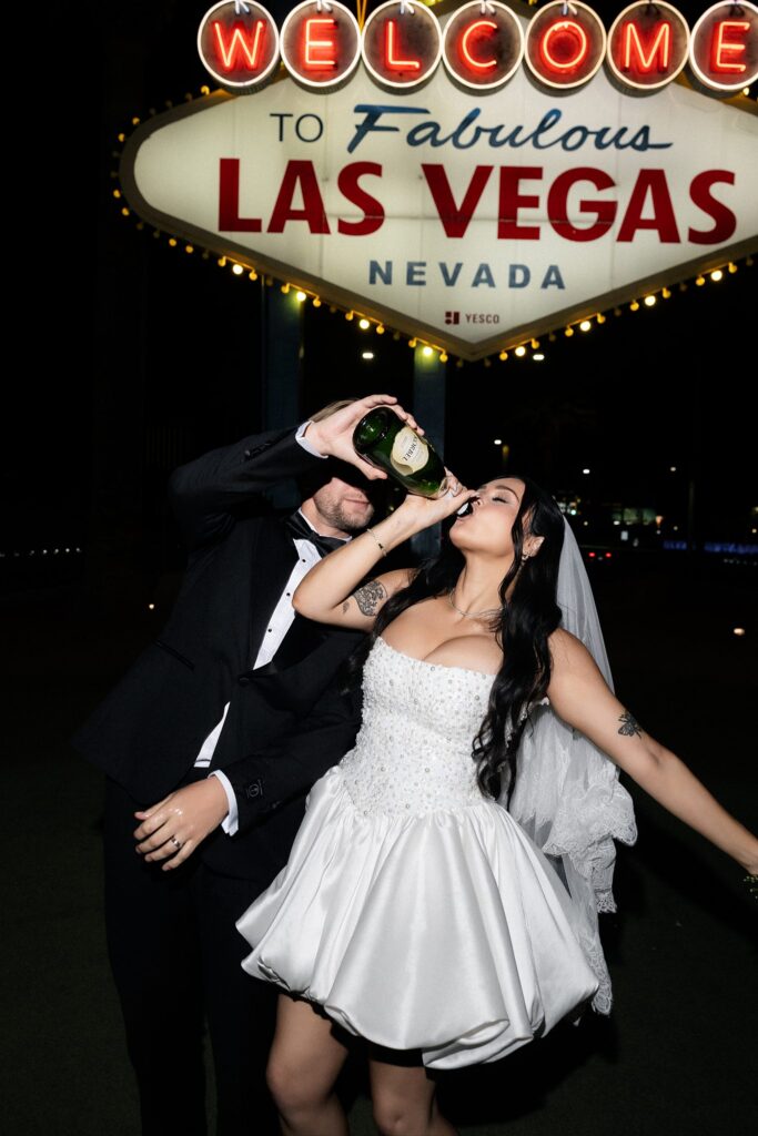 Bride drinking straight from a champagne bottle during her Las Vegas elopement.